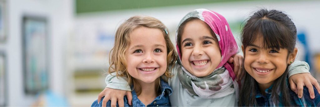 First-Class-Pre-K-Header slider image of three girls smiling
